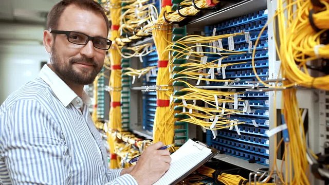Engineer working in data room. Slow motion.