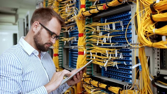 Engineer working in data room. Slow motion.