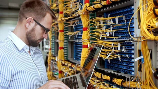 Engineer working in data room. Slow motion.