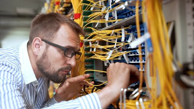 Engineer working in data room. Slow motion.
