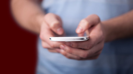 Young man holding smarthphone in hand