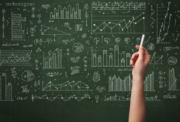 A business person drawing data on chalkboard