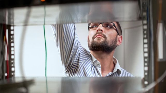 Engineer working in data room. Slow motion.