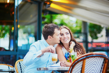Happy romantic couple in Parisian cafe