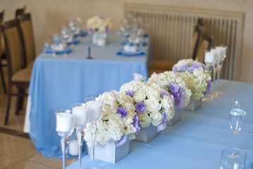 Nicely decorated wedding table with flowers and candles 