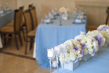 Nicely decorated wedding table with flowers and candles 