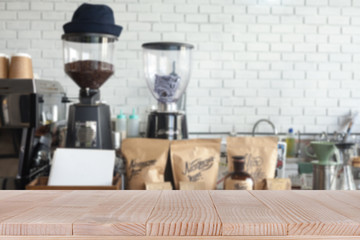 Wood table top on abstract blurred coffee shop background - can