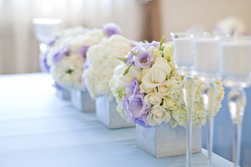 Nicely decorated wedding table with flowers and candles 
