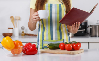 woman holding a cup of coffee in her kitchen