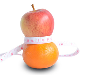 Concept eat orange and apple are in good shape.Orange and apple wrapped with a tape measure. on white background