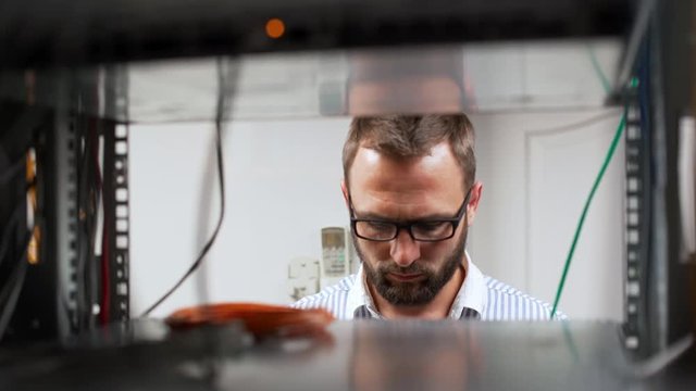 Engineer working in data room.