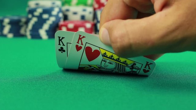 Poker Chips and Two Kings on green background