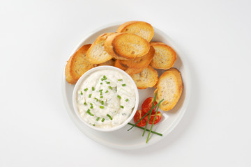 sliced toasted baguette and chives spread
