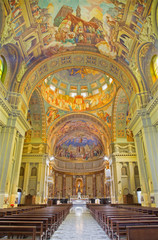 Fototapeta na wymiar ROME, ITALY - MARCH 10, 2016: The nave of church Basilica di Santa Maria Ausiliatrice with the frescoes by the Salesian priest and artist Don Giuseppe Melle 20. cent.