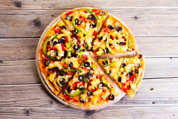 Delicious italian pizza served on wooden table