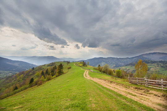 Trail in the countryside and mountains in the background. Carpat