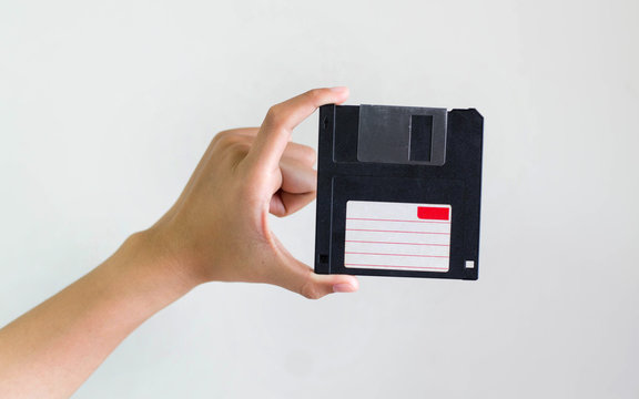 Closeup image: hand holding blackFloppy Disk data storage