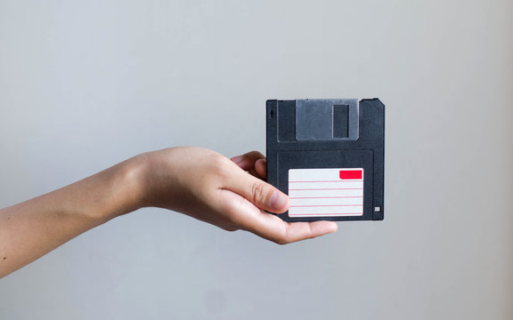 Closeup image: hand holding blackFloppy Disk data storage