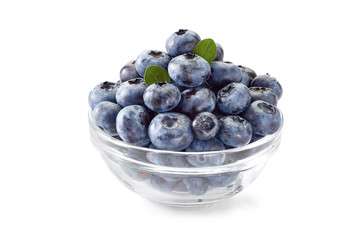 Blueberries in glass bowl on white.