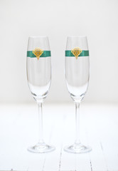 Two elegant champagne glasses with decoration ribbon.White background.Shallow depth of field 