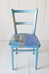 old vintage blue wooden chair on a white background 