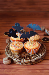 Halloween orange sprinkled cupcakes with pumpkin cream and ghost