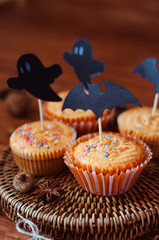 Halloween orange sprinkled cupcakes with pumpkin cream and ghost