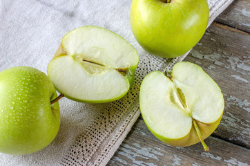 Green apples on the old boards
