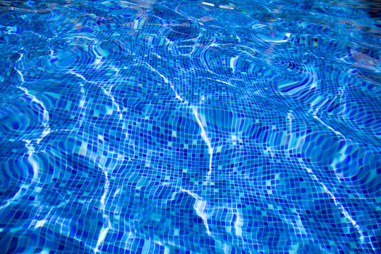 reflection  blue  water  of swimming pool with mosaic bottom