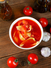 Still life with tomatoes and onion sauce