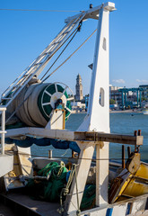 fishing boats anchored in the harbor. Carefully positioned nets and other fishing gear at sea