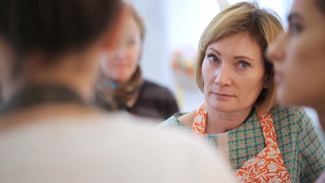 Group of women discuss with each other theme of seminar