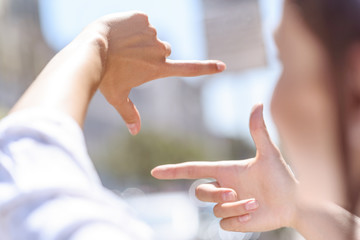 Female photographer focusing on town scenery