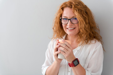 Cheerful woman drinking tea.