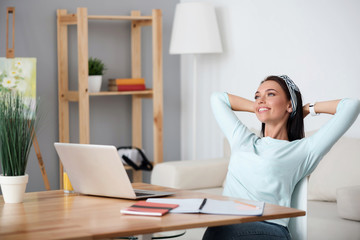 Positive delighted woman sitting at the table