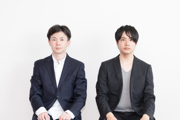 椅子に座る2人の男性