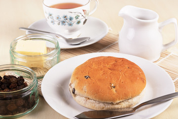 Tea with a traditional British teacake of raisins, sultanas and
