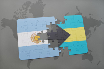 puzzle with the national flag of argentina and bahamas on a world map background.