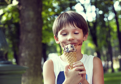little boy eating an ice cream dessert