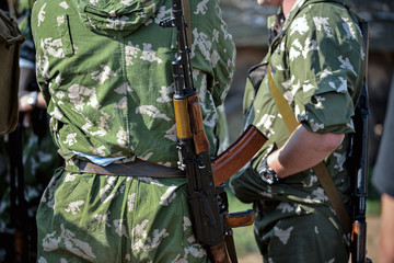 Soldiers in uniform with rifles standing