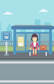 Woman waiting for bus at the bus stop.