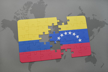 puzzle with the national flag of colombia and venezuela on a world map background.