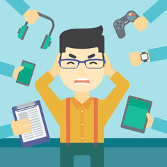 Young man surrounded with his gadgets.