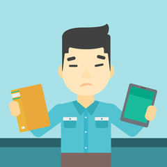 Man choosing between book and tablet computer.