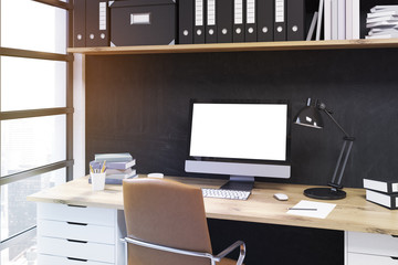 Office desk with lamp and computer.