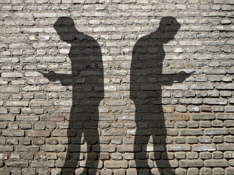 two men with smartphones ignoring each other