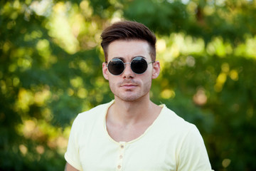 Attractive guy in the park with sunglasses