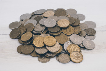 Heap of coins on a wooden background. Coins of Russian Federation.