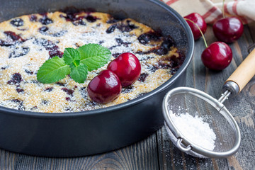 Clafoutis with cherry in baking dish, horizontal