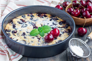 Clafoutis with cherry in baking dish, horizontal